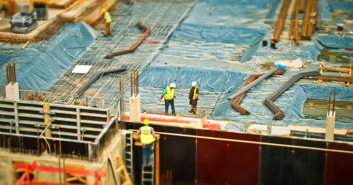 Construction site with blueprints representing quantity surveying courses in Kerala